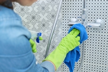 Sparkle Window's expert cleaning team meticulously scrubbing a bathroom to shine in a Brisbane home.