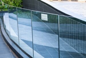 Cleaning balustrade and pool glass to enhance outdoor visibility and safety